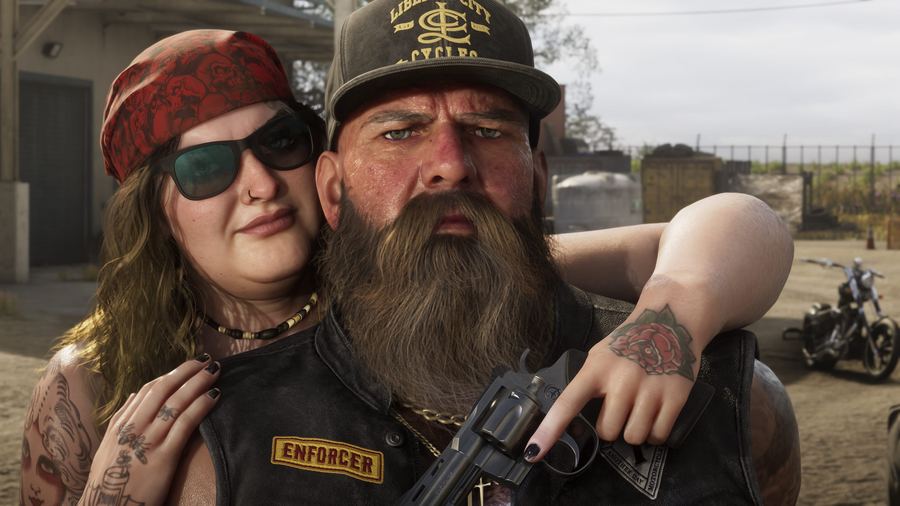 A biker couple posing together, the man in an Enforcer vest