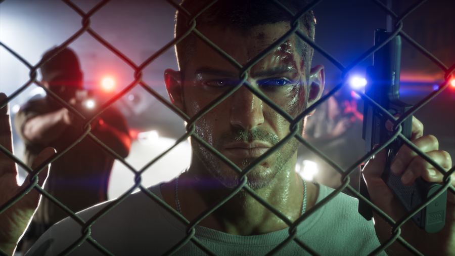 Jason Duval lit by red and blue police lights through a chain-link fence