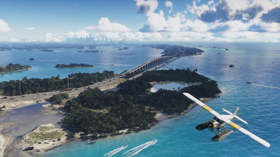 A seaplane on turquoise water beside a causeway linking small islands