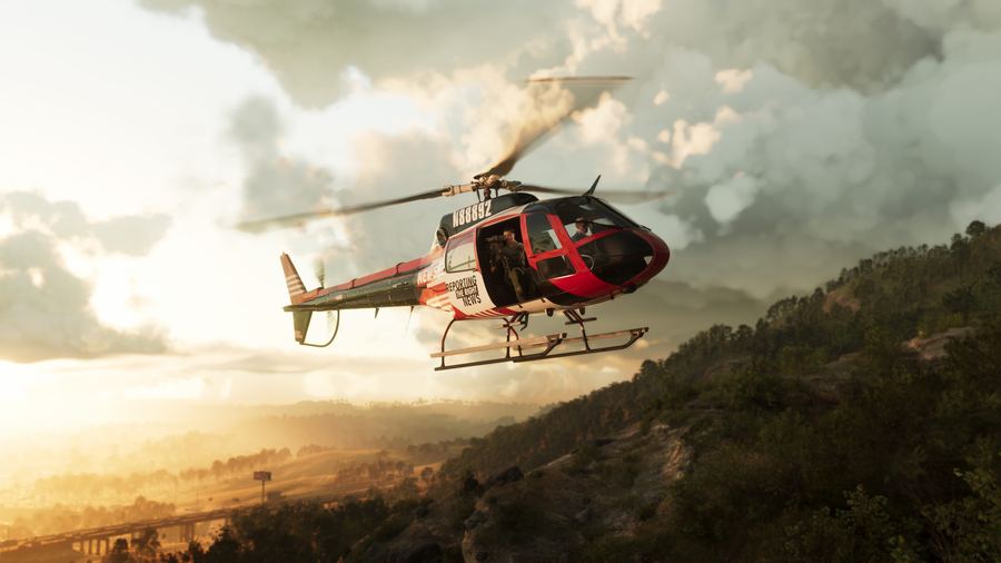 A red and white helicopter flying low over forested hills at sunset