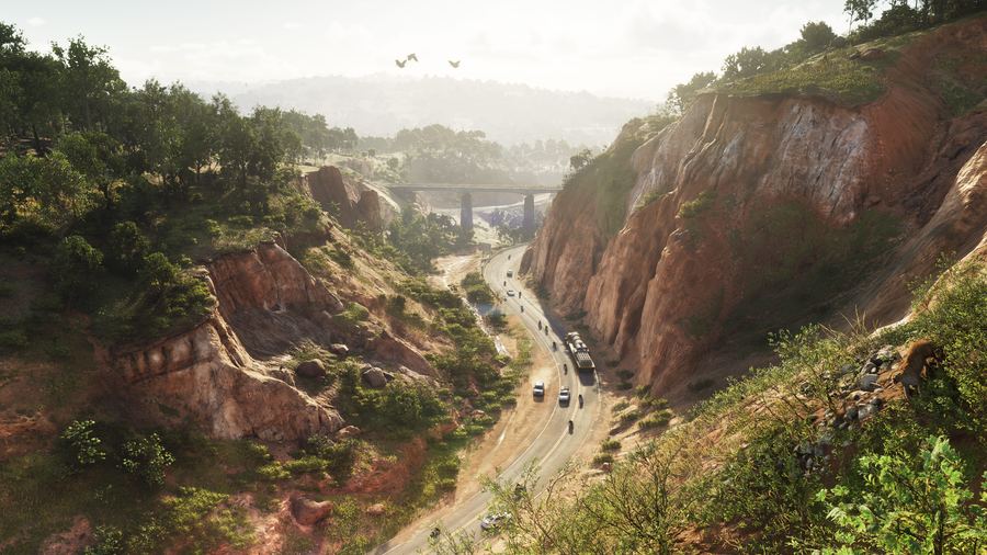 A highway cutting through a red rock canyon