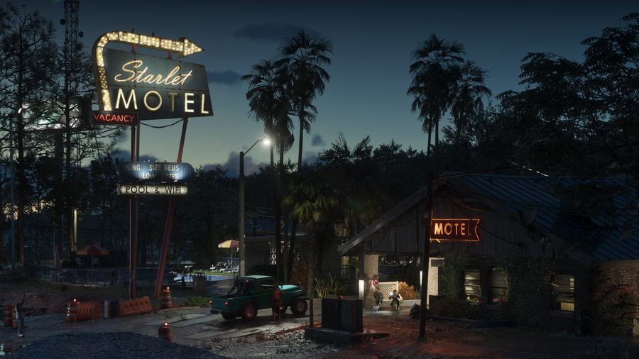 The Starlet Motel sign lit at night on an empty street