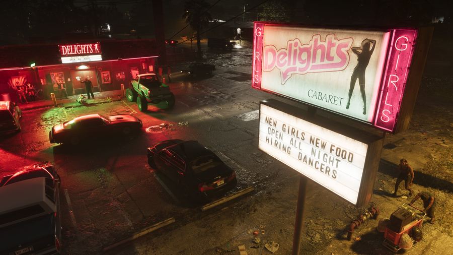 A neon-lit roadside strip club and diner signage at night