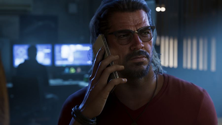 Raul Bautista talking on a phone in a dark office