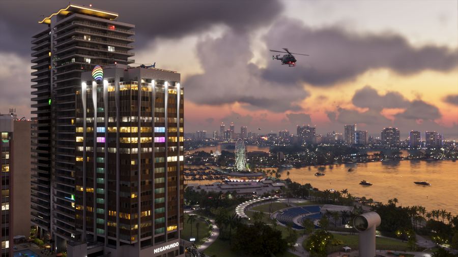 A tall Vice City tower at golden hour with the bay behind it
