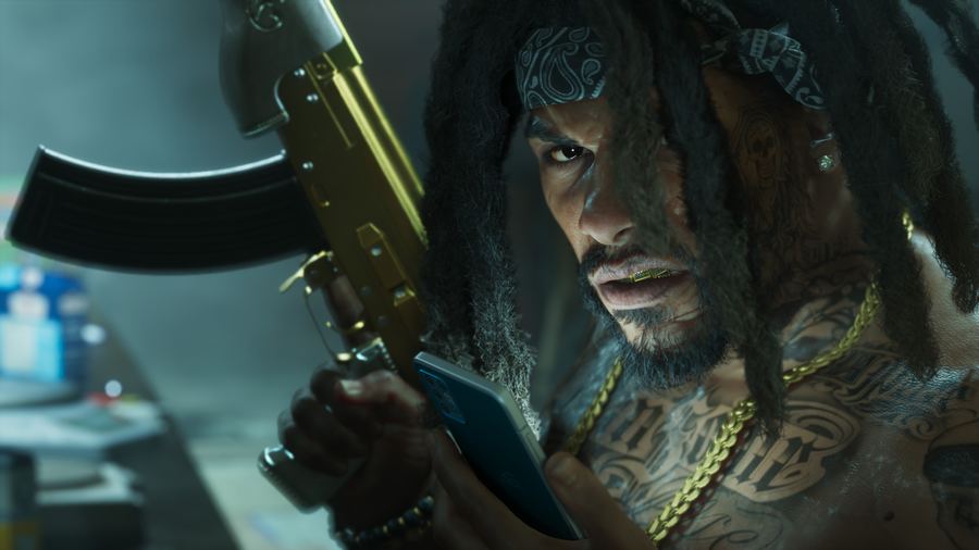 A man in gold chains holding a pistol under blue night lighting